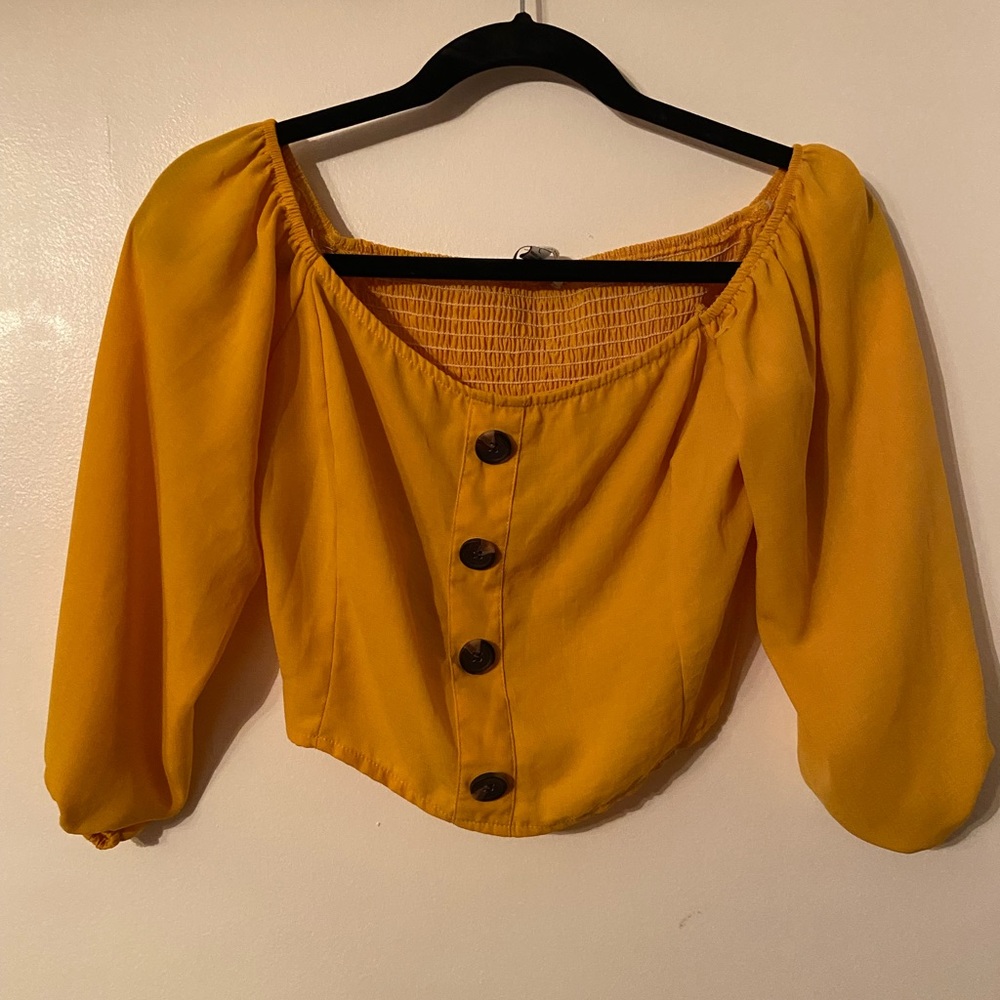 Mustard color top with brown buttons